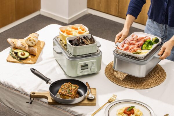 Steamer with seafood, pasta, and bread.