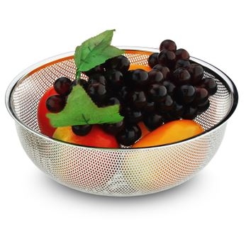 A bowl of fruit is shown with leaves.