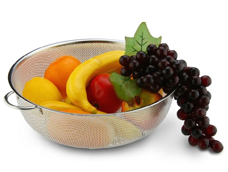 A bowl of fruit is sitting on the table.