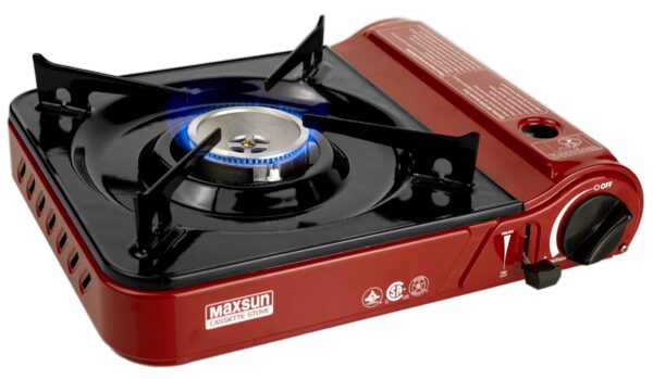 Red portable camping gas stove with blue flame.