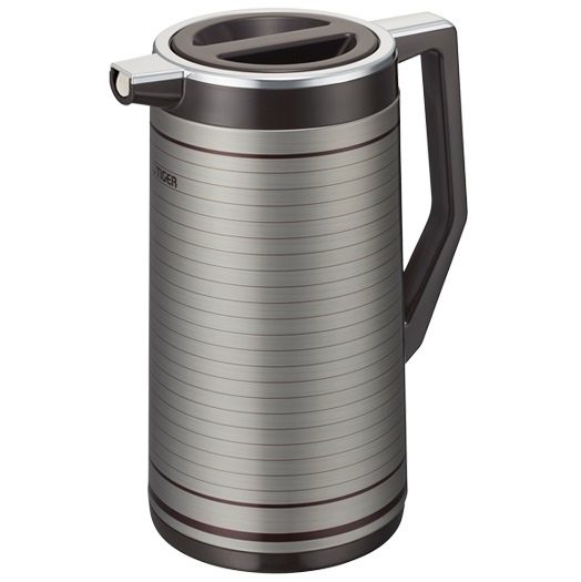 A silver and black thermos is sitting on the floor.