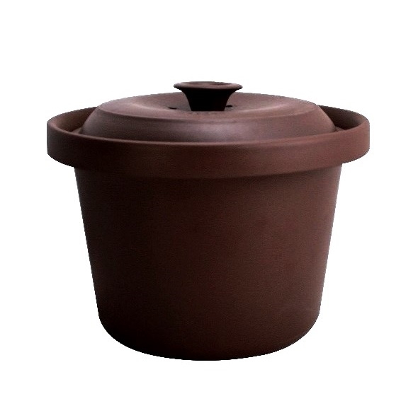 A brown pot with lid on top of it.