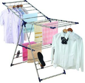 Clothes drying rack with folded clothes.