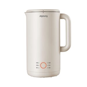 A white electric kettle sitting on top of a table.