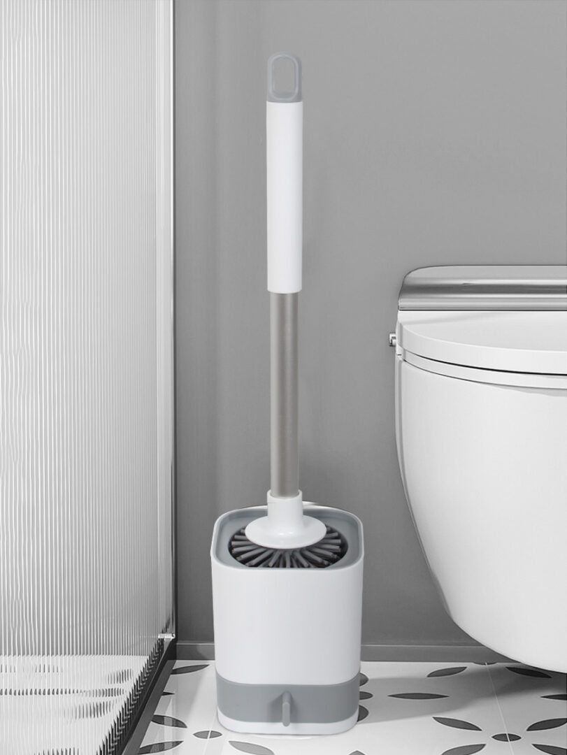 Aodi Q17 toilet brush and matching holder standing beside a toilet