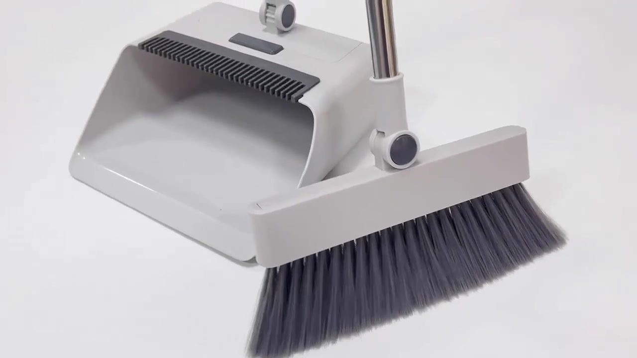 Q10 broom beside the dustpan showing the built-in comb